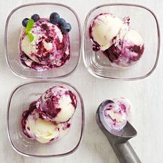 four bowls with ice cream and berries in them