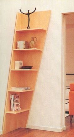 an orange chair sitting in front of a book shelf