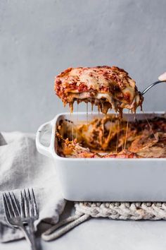 someone is taking a slice of pizza from the casserole dish on instagram