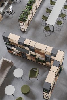 an overhead view of office cubicles with tables, chairs and planters on them