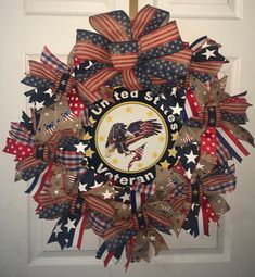 a patriotic wreath with an eagle, stars and stripes on the front door for veterans day