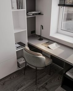 a desk with a chair, bookshelf and lamp in the corner next to it