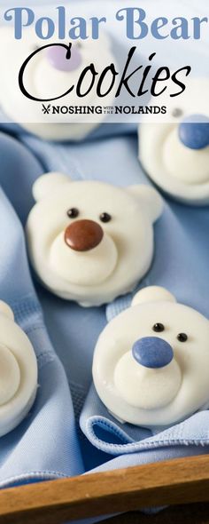 there are some cookies with white frosting and blue decorations on them that look like polar bears