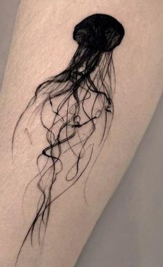 a black and white photo of a jellyfish tattoo