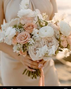 a woman holding a bouquet of flowers in her hands