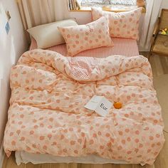 a bed with pink and white polka dots on it