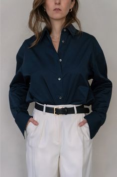 Oversized tailored shirt with drop shoulder. Box center pleat at back, with rounded hem and extended tail. Shell buttons. Oversized fit. Wear your normal size for an oversized fit or size down for a more traditional fit. Model is wearing an XS. 100% cotton. Gentle machine wash cold, inside out, with like colors. Lay flat to dry. Cheap Navy Shirt For Women, Luxury Navy Shirt For Spring, Luxury Blue Shirt For Fall, Cheap Blue Workwear Blouse, Cheap Blue Shirt For Fall, Luxury Blue Tops For Workwear, Navy Blue Button Up Shirt Outfit, Shirt Outfits Women Formal, Dark Blue Button Down Shirt Outfit