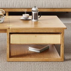 a coffee table with a book and cup on it