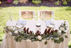 the table is set with mr and mrs signs