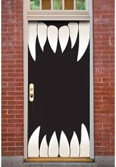 an open door with white teeth painted on the front and side of it to look like a monster's mouth