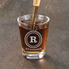 a glass filled with liquid sitting on top of a table next to a toothbrush