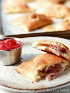 ham and cheese pastries on a plate with a small bowl of ketchup