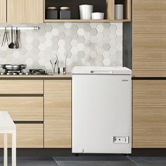 a white dishwasher sitting in the middle of a kitchen next to wooden cabinets