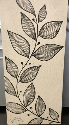 a black and white drawing of leaves on a piece of paper