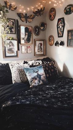 a bed with many pictures on the wall and lights strung from it's headboard