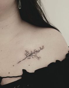 a woman with a flower tattoo on her chest