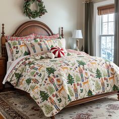 a christmas themed bed in a bedroom next to a window