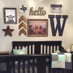 a baby's room with pictures on the wall and a crib in front of it