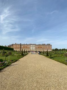 a long gravel road leading to a large building