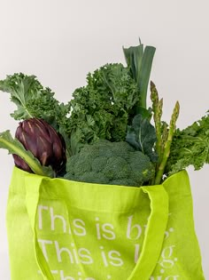 a bag filled with lots of green vegetables