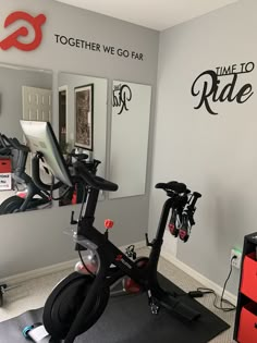 there is a stationary bike in the corner of this room with mirrors on the wall