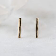 simple, edgy + modern. These minimal fine metal bar earrings are a perfect addition to your ear stack! Adding a modern + edgy vibe. Earring Specifications: hand-crafted gold bar studs measure 10 x 2mm lightly hammered + polished finish choose from 14k gold, gold filled or sterling silver Gold Bar Earrings, Stud Earrings Gold, Bar Stud Earrings, Ear Stack, Bar Studs, Metal Bar, Bar Earrings, Gold Bar, Gold Earrings Studs