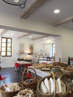 a room filled with lots of different types of breads and pastries on tables