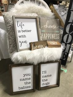 two wooden frames with white fur on them and some signs that say life is better with you