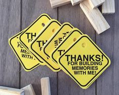 three yellow signs that say thanks for building memories with me on wooden planks next to each other