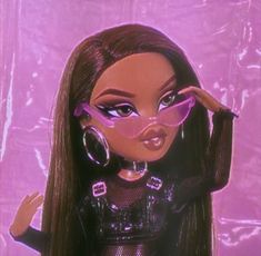 a barbie doll with long brown hair and purple eye make - up on her face