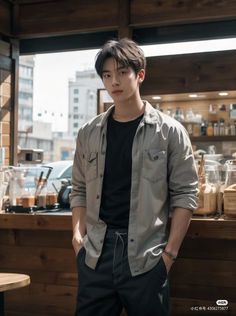 a young man standing in front of a counter