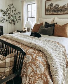 a bedroom with a large bed and lots of pillows