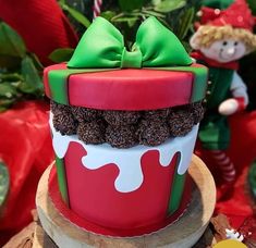 a decorated christmas cake sitting on top of a table