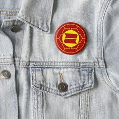 a red and yellow iron man emblem on a denim jacket with buttons in the pocket