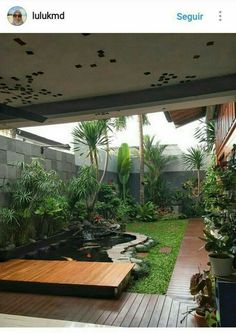 an outdoor garden with wooden decking and plants