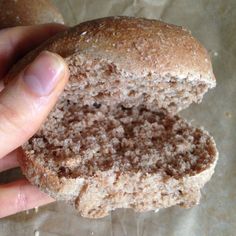 a person holding a half eaten doughnut in their hand