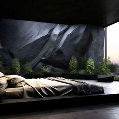 a large bed sitting in the middle of a room next to a window with mountains on it