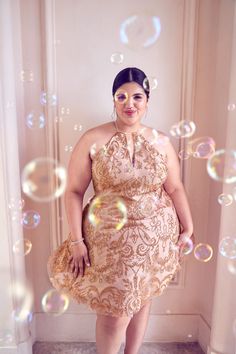 a woman is standing in front of bubbles