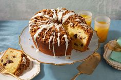 a bundt cake with white icing and crumbs sits on a plate