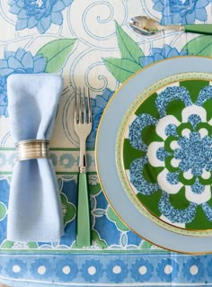 a blue and green place setting with silverware