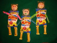 three bags of candy shaped like people holding toothbrushes