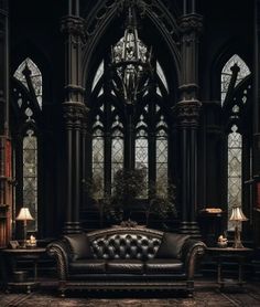 an old fashioned leather couch in front of a chandelier and stained glass windows