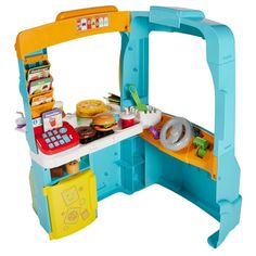 a toy kitchen with food on the counter