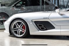 a silver sports car parked in front of two other cars