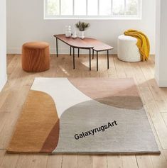 a rug with the word galaxy art on it in front of a table and two stools