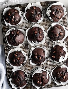 chocolate muffins in white paper cups on a baking tray, ready to be eaten