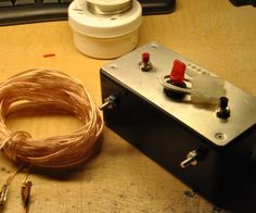 an electrical device sitting on top of a wooden table next to a mouse and wires