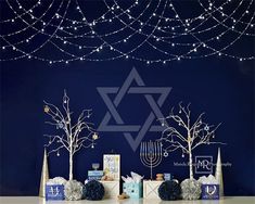 the table is set up with decorations and gifts for hanukkah, jewish holiday