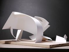 a white sculpture sitting on top of a wooden table