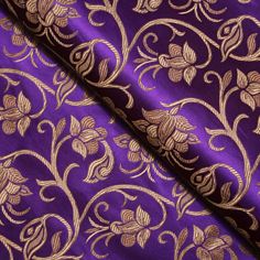 purple and gold brocaded fabric